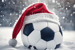 A football in snow with a christmas hat on