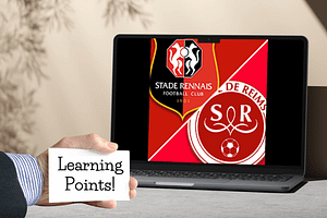 hand with learning point text on card screen in background with rennais and reims football emblems.