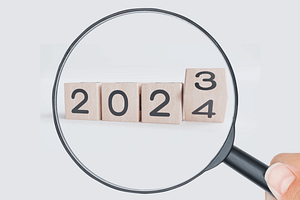 magnifying glass looking at 2023-2024