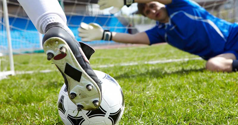 lay-the-draw-trading-image A football player about to score a goal.