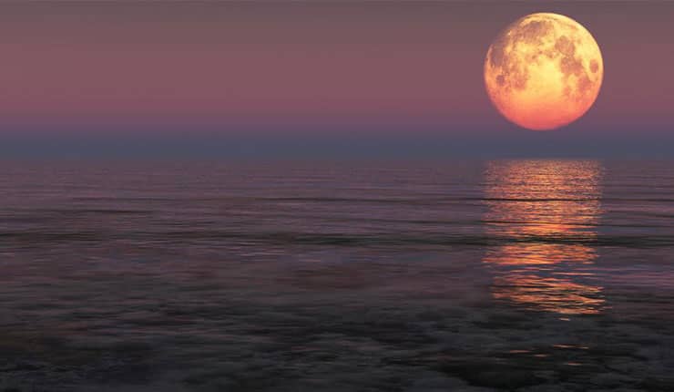 Large supermoon over the ocean.