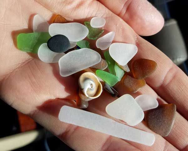 Handful of green sea glass, white  sea glass and brown sea glass found on Point Pleasant beach.