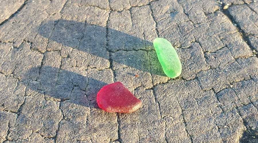 Green and red sea glass found at Southbourne Beach, Bournemouth