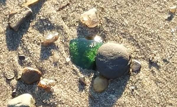 Image of green sea glass found on the beach at Lands End Beach on Bailey Island.