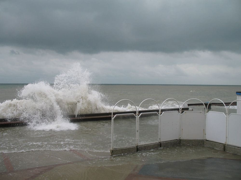 Large waves breaking over a sea wall.