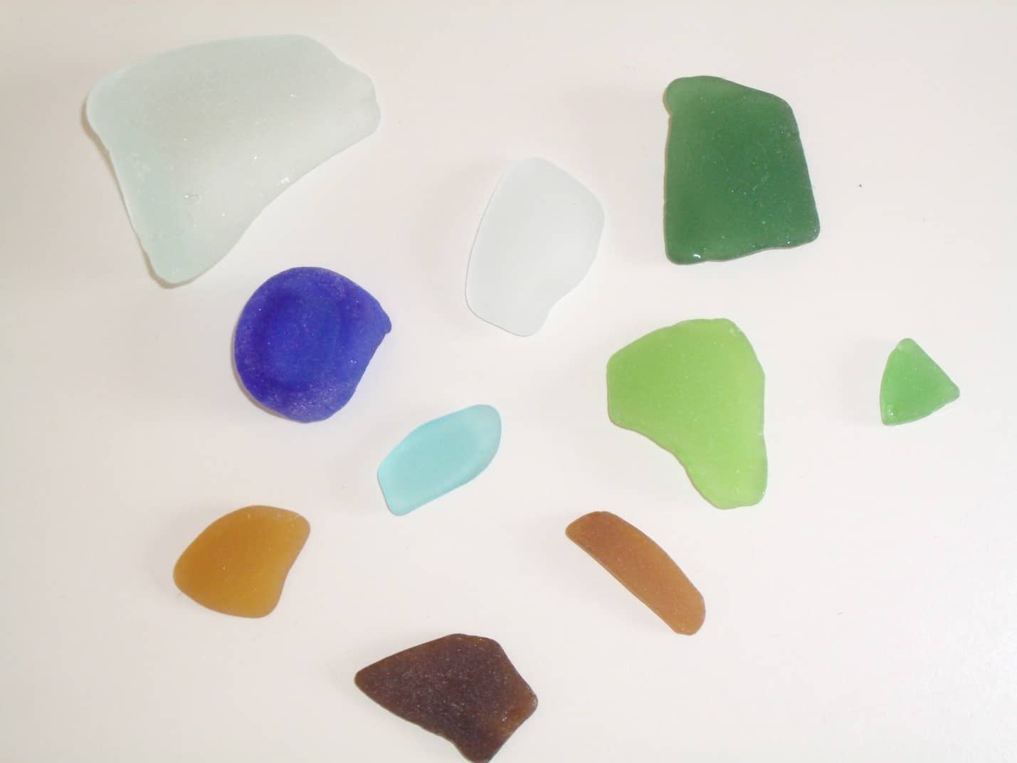 Various colors of sea glass, including green, blue, clear, aqua, brown and amber.