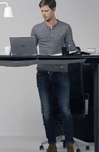 Man using his laptop at a standing desk