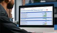 A man looking at Team Stats on his laptop