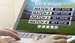 Placing live soccer bets on a laptop