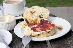 Clotted cream, fruit scone, strawberry jam and a pot of tea at the National Trust café, Corfe Castle.
