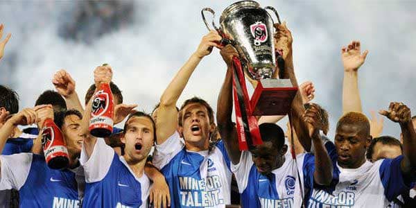 The Genk squad lift the Jupiler Pro League trophy after winning the 2010/11 title.