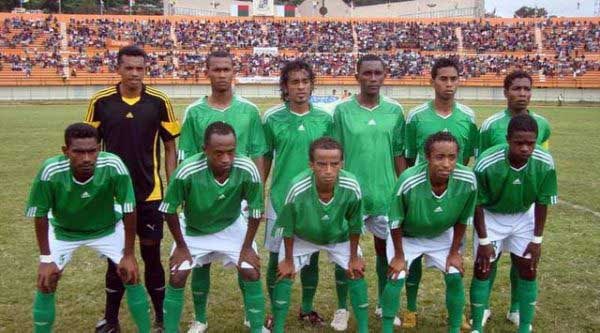 Madagascan football team SO Emyrne line up in their green jerseys ahead of a match.