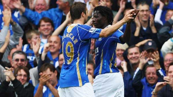Portsmouth striker Benjani celebrates with team-mate Niko Kranjcar after scoring his third goal in their 7-4 victory over Reading.