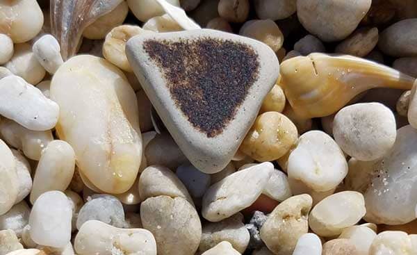 Piece of brown wave tumbled sea pottery.