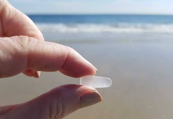 Holding white sea glass on Point Pleasant beach.