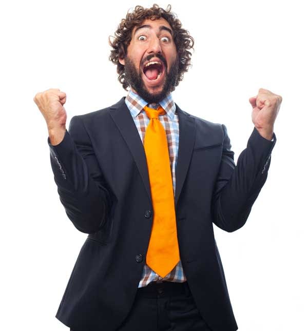 Bearded man in a suit celebrating a risk-free betting win