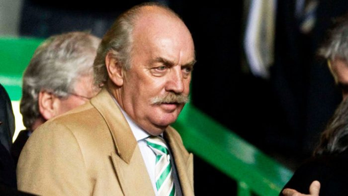 Shareholder Dermot Desmond stands in the crowd at a Celtic FC match.