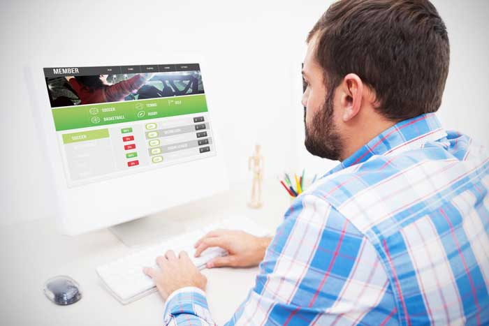 Man logging in to his online betting exchange account.