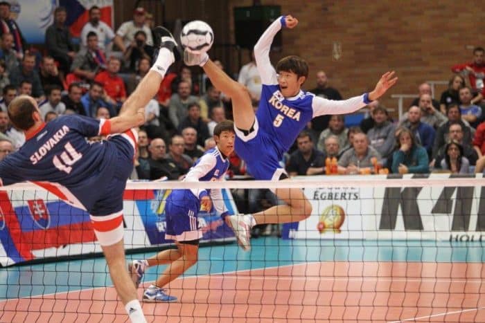 Two players stretch to win the ball at the Futnet World Championship.