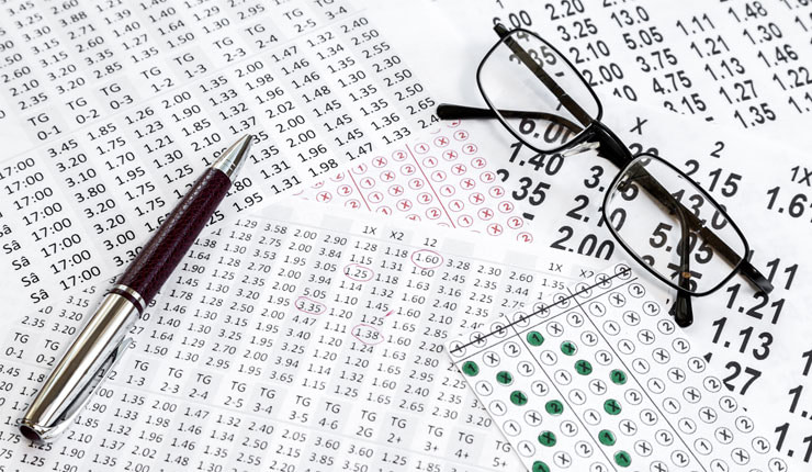 Betting slips, spectacles and a pen.