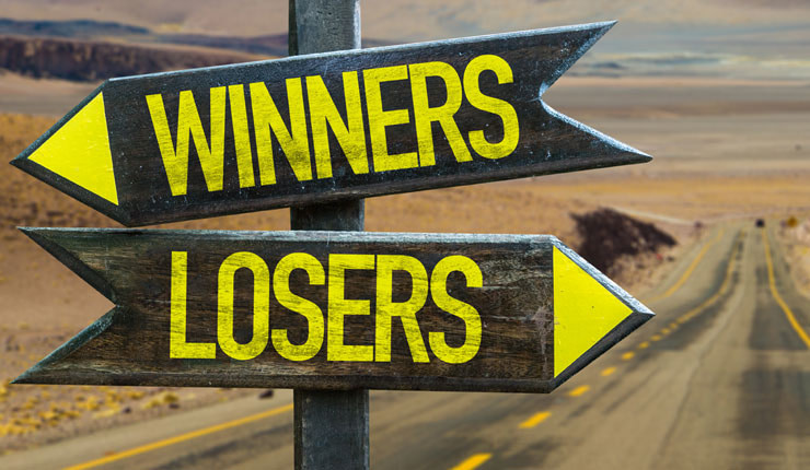 Desert road with signpost directing Winners and Losers