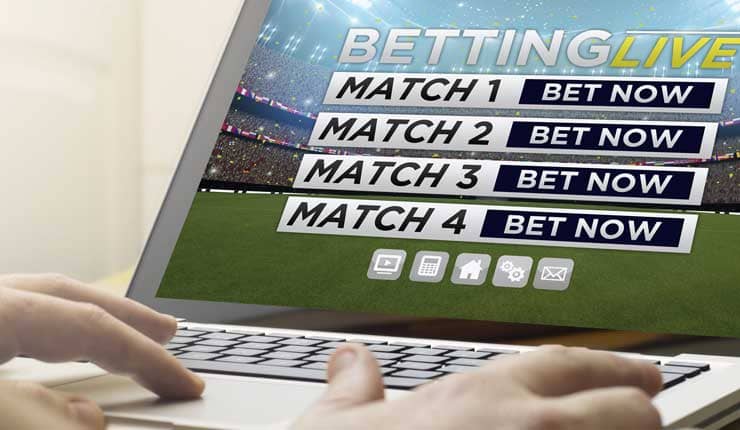 Placing live soccer bets on a laptop