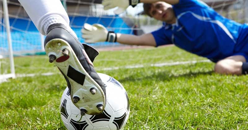 lay-the-draw-trading-image A football player about to score a goal.